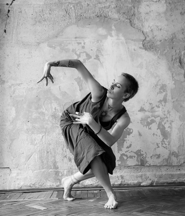 Woman in a fluid motion pose against a clean background.